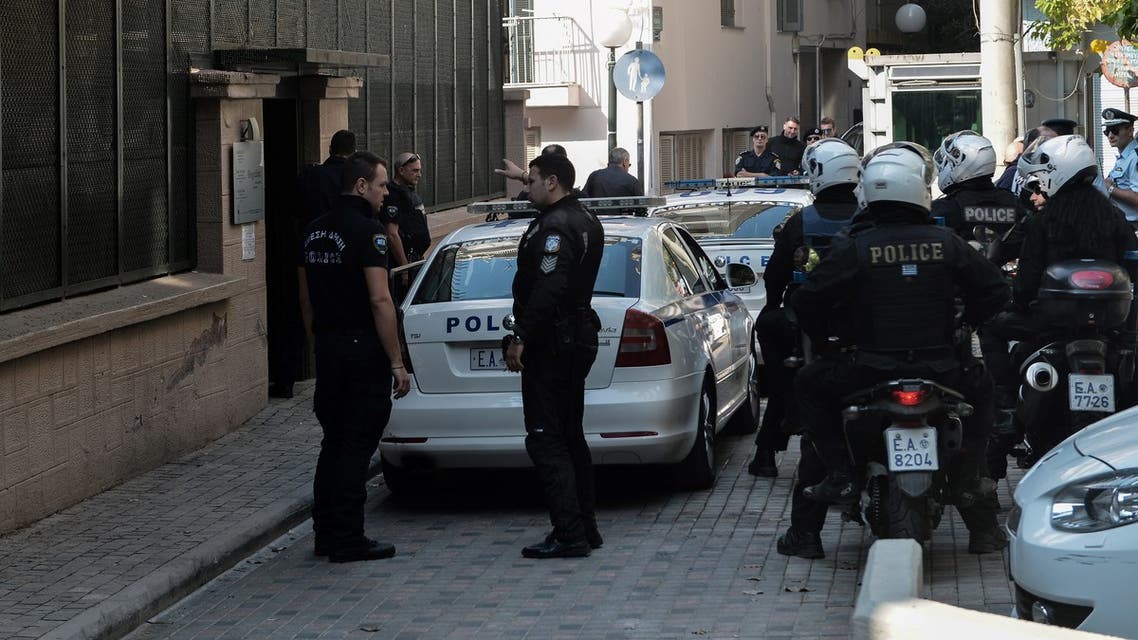 Police officers stand guard outside of the Turkish Consulate after a demonstration against the Turkey's military operation in northeastern Syria by anarchist group of Rouviconas, in Thessaloniki on October 17, 2019.