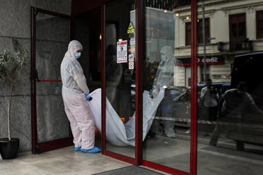 Forensic medicine staff carry a body bag, allegedly containing the remains of Gholamreza Mansouri, outside a hotel in downtown Bucharest. (Reuters)