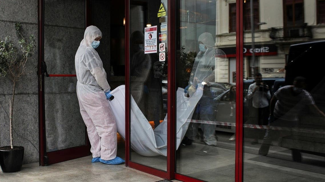 Forensic medicine staff carry a body bag, allegedly containing the remains of Gholamreza Mansouri, outside a hotel in downtown Bucharest. (Reuters)