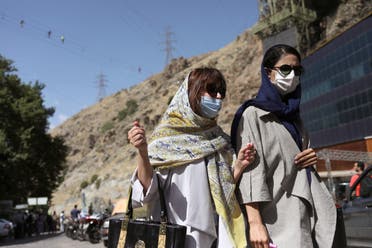 Iranian women wearing protective face masks walk in Darband street, following the outbreak of the coronavirus disease (COVID-19), in Tehran, Iran June 12, 2020. (Reuters)