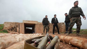 Syrian soldiers stand next to ammunition and packs they say are of C-4 explosives that were found in the southern province of Daraa on February 27, 2019, during a government-organised trip for journalist. Daraa was once seen as the cradle of Syria's seven-year uprising, but in July regime forces took back control through a military push and deals that saw rebels surrender.