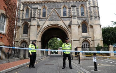 Police stand guard at the Abbey gateway of Forbury Gardens, a day after a multiple stabbing attack in the gardens in Reading, England on June 21, 2020. (AP)
