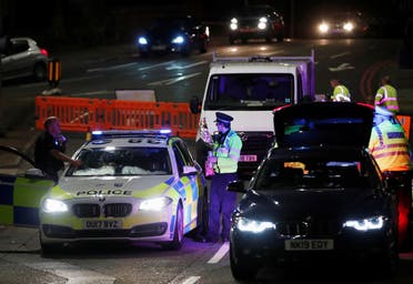 Police officers and their vehicles are seen at a cordon at the scene of reported multiple stabbings in Reading, Britain. (Reuters)