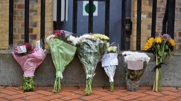 Floral tributes are seen at a police cordon at the Abbey Gateway near Forbury Gardens park in Reading, west of London, on June 21, 2020. (AFP)