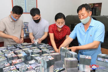 This undated picture released by North Korea's official Korean Central News Agency (KCNA) on June 20, 2020 shows North Koreans preparing anti-Seoul leaflets at an undisclosed location in North Korea. (AFP)