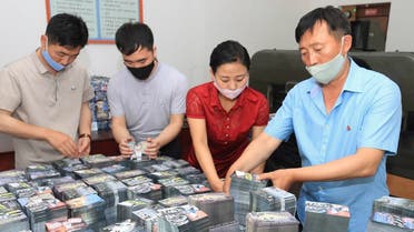 This undated picture released by N.Korea's official Korean Central News Agency on June 20, 2020 shows N.Koreans preparing anti-Seoul leaflets at an undisclosed location in North Korea. (AFP)