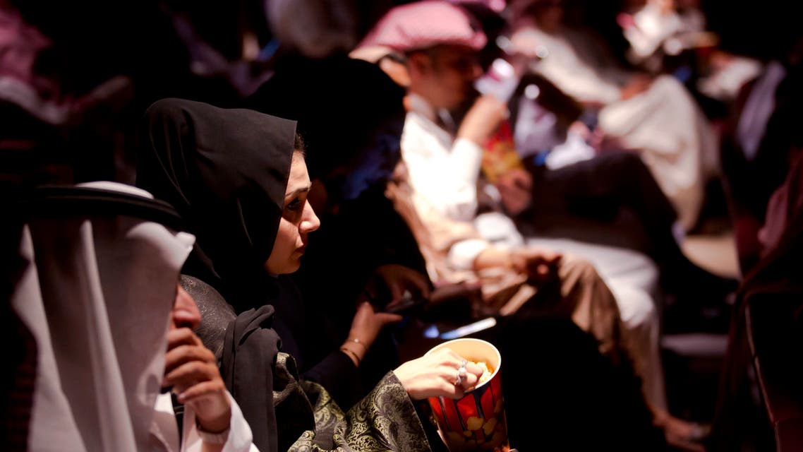 Visitors eat popcorn as they attend an invitation-only screening, at the King Abdullah Financial District Theater, in Riyadh, Saudi Arabia. (File photo: AP)