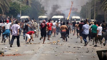 Tunisian protesters clash with security forces as they demonstrate in the southern city of Tataouine on June 22, 2020. (AFP)