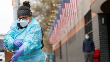 An EMT before going into Elmhurst Hospital during the ongoing outbreak of the coronavirus disease in New York, April 20, 2020. (Reuters)