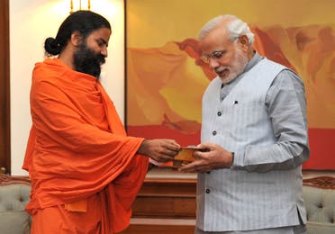 Yoga guru Baba Ramdev (L) calls on Indian Prime Minister Narendra Modi in New Delhi on November 4, 2014. (AFP)