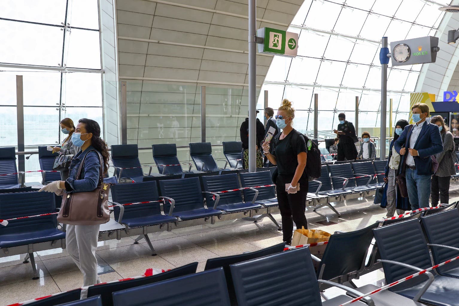 Passengers keep distance in a line at Dubai International Airport amid the outbreak of the coronavirus in Dubai, UAE, April 27, 2020. (Reuters)
