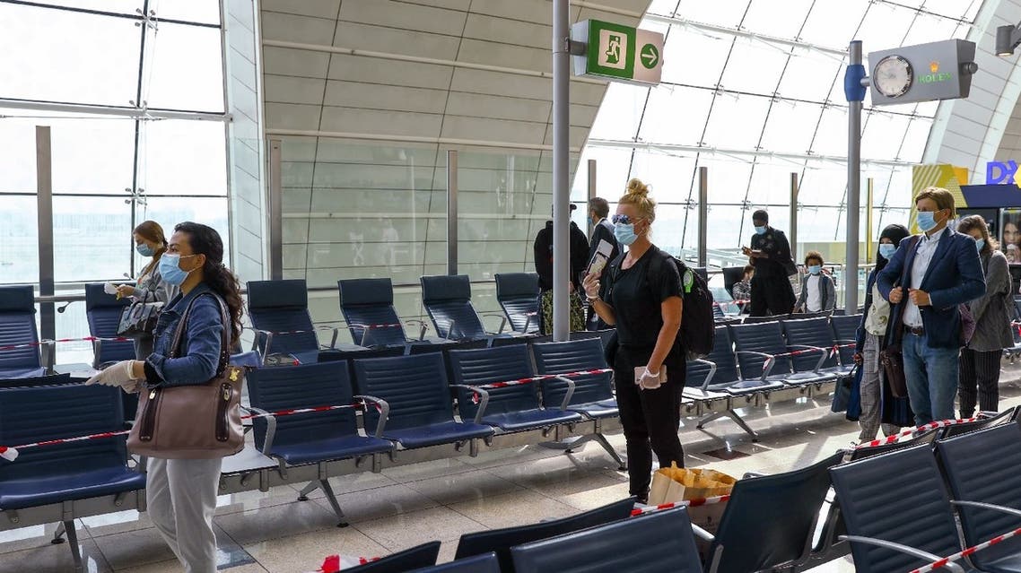 Passengers keep distance in a line at Dubai International Airport amid the outbreak of the coronavirus in Dubai, UAE, April 27, 2020. (Reuters)