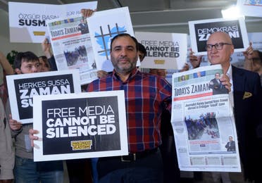 Bulent Kenes, then-editor-in-chief of Today's Zaman, shows his newspaper minutes before police detain him in his office in Istanbul on Oct. 9, 2015. (AP)