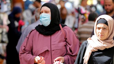 A Palestinian woman wearing a mask shops at a market ahead of the upcoming holiday of Eid al-Fitr marking the end of Ramadan, amid concerns about the spread of the coronavirus disease (COVID-19) in Bethlehem in the Israeli-occupied West Bank May 19, 2020. Picture taken May 19, 2020. (Reuters)