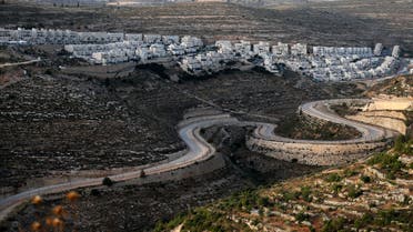A serpentine road extends between the Jewish settlement of Givat Zeev (background) and Palestinian villages near the Israeli-occupied West Bank city of Ramallah, on June 10, 2020. Israel intends to annex West Bank settlements and the Jordan Valley, as proposed by US President Donald Trump, with initial steps slated to begin from July 1.