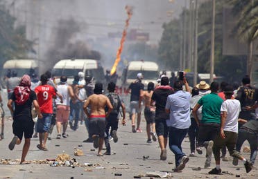 Tunisian protesters clash with security forces as they demonstrate in the southern city of Tataouine on June 22, 2020. (AFP)