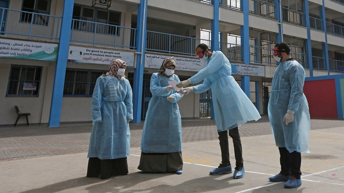Palestinian health workers in the courtyard of a UNRWA refugees school at al-Shati refugee camp in Gaza City on March 18, 2020. (AFP)
