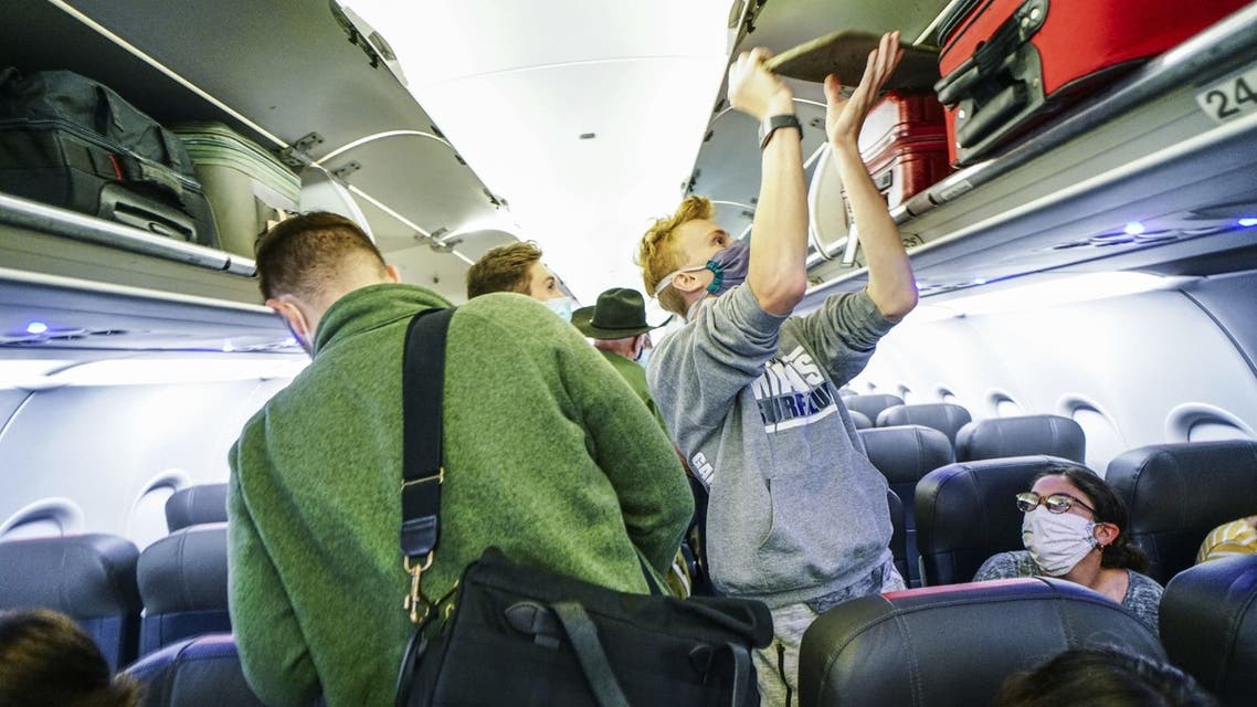 Passengers board an American Airlines flight to Charlotte, North Carolina at San Diego International Airport on May 20, 2020 in San Diego, California, US. (AFP)
