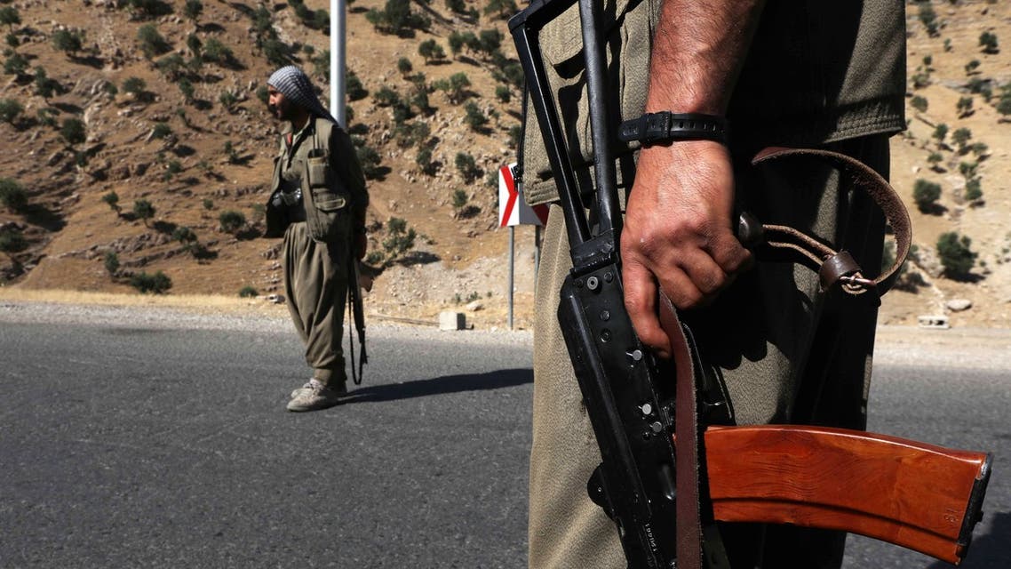 Members of the Kurdistan Workers' Party (PKK) carry rifles as they stand guard on a road in the Qandil Mountains, the PKK headquarters in northern Iraq. (File photo)