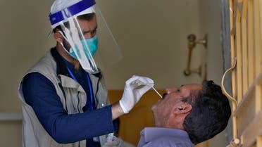 A health worker takes a nasal swab sample of a person during door-to-door testing and screening facility for the new coronavirus, in Islamabad, Pakistan, Monday, June 15, 2020. (AP)