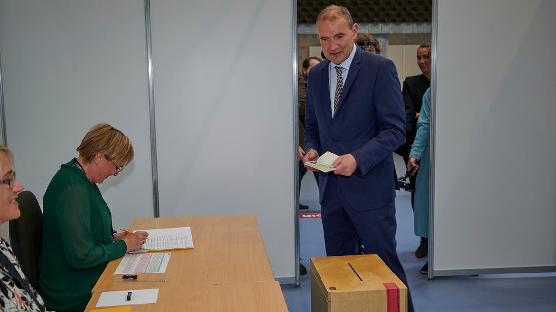 Sitting President of Iceland, Gudni Th Johannesson (L) arrives to cast his vote at the polling station 'Altanesskoli' in Gardabaer, Iceland on June 27, 2020.
