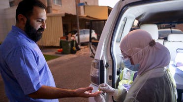 A Kuwaiti health ministry worker conducts a random test for the novel coronavirus (COVID-19) in Kuwait City on June 27, 2020. 