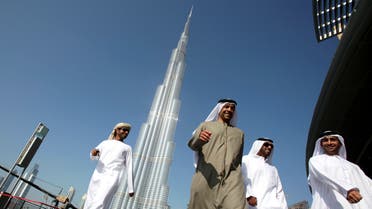 Emirati men walk past the Burj Khalifa, January 4, 2010. (Reuters)