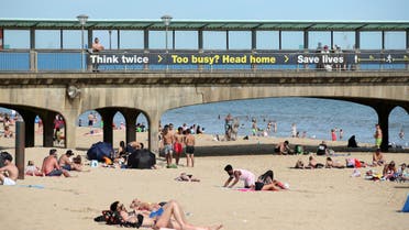 People relax on a beach enjoying the weather in Bournemouth, following the outbreak of the coronavirus disease (COVID-19), Bournemouth, Britain, May 26, 2020. (Reuters)