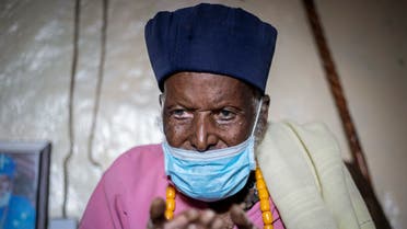 Centenarian Tilahun Woldemichael crys as he prays to God after spending weeks in hospital recovering from the coronavirus, at his house in Addis Ababa, Ethiopia Saturday, June 27, 2020. The Ethiopian monk believed to be 114 years old has survived the coronavirus and was discharged from a hospital on Thursday, having received oxygen and dexamethasone, a cheap and widely available steroid that researchers in England have said reduced deaths by up to one third in severely ill hospitalized patients. (AP Photo/Mulugeta Ayene)