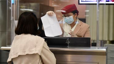 A passenger of an Emirates airlines flight departing to the Australian city of Sydney, checks in at Dubai International Airport. (File photo: AFP)