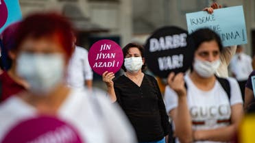 A woman hold placard reading '' Women, Life and Freedom '' during a protest against the detention of three opposition lawmakers, in Istanbul, Turkey, on June 6, 2020. Turkish police on June 4, 2020 detained three opposition lawmakers after the parliament stripped them of their jobs, triggering furious charges that President Recep Tayyip Erdogan's government is seeking to further consolidate authoritarian rule.