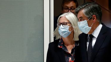 Former French prime minister Francois Fillon and his wife Penelope, wearing protective face masks, leave following the verdict in their trial over a fake jobs scandal at the courthouse in Paris, France, June 29, 2020. REUTERS/Gonzalo Fuentes