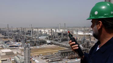 A Kuwaiti oil worker talks on his radio at Mina Abdulah Oil Refinery, 50 Km South of Kuwait City in this file photo taken April 2005. (AP)