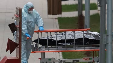 A medical specialist pulls a stretcher outside a hospital for patients infected with the coronavirus disease on the outskirts of Moscow. (Reuters)
