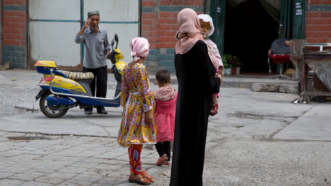 A Uighur woman wears a full length garment and headscarf in the city of Aksu in western China's Xinjiang province. (AP)
