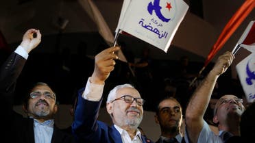 Rached Ghannouchi, leader of the Islamist party Ennahda, waves the party flag outside Ennahda's headquarters in Tunis October 27, 2014.Tunisia's Ennahda party, the first Islamist movement to secure power after the 2011 Arab Spring revolts, conceded defeat on Monday in elections that are set to make its main secular rival the strongest force in parliament. Official results from Sunday's elections - the second parliamentary vote since Tunisians set off uprisings across much of the Arab World by overthrowing autocrat Zine El-Abidine Ben Ali - were still to be announced. REUTERS/Zoubeir Souissi (TUNISIA - Tags: ELECTIONS POLITICS)