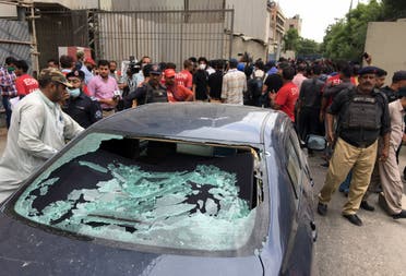 Plainclothes police officer surveys site of attack at Pakistan Stocks Exchange entrance in Karachi. (Reuters)