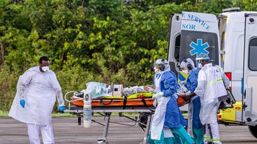 Medical staff carry a patient infected with the novel coronavirus (Covid-19) into an Airbus A400M at Guiana air-base 367 in Matoury, near Cayenne, in the French overseas department of Guiana, on June 28, 2020, to strengthen the medical evacuation capacities of patients to hospitals in the region, during the spread of the coronavirus. 
