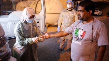 A Kuwaiti health ministry worker conducts a random test for the novel coronavirus (COVID-19) in Kuwait City on June 27, 2020. 