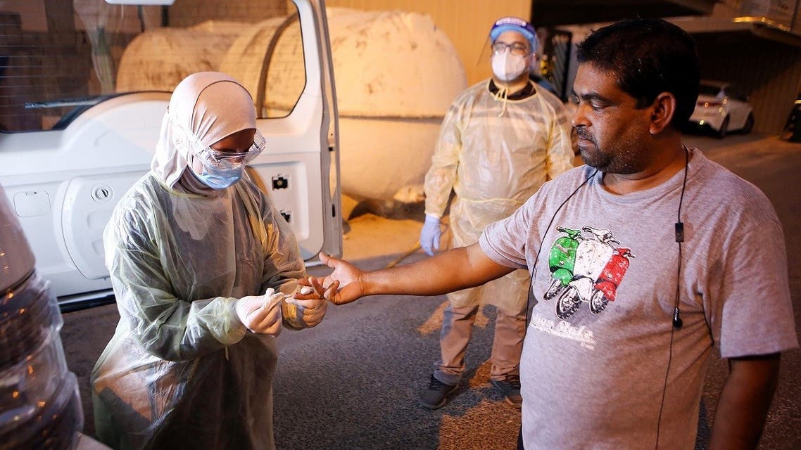A Kuwaiti health ministry worker conducts a random test for the novel coronavirus (COVID-19) in Kuwait City on June 27, 2020. (AFP)