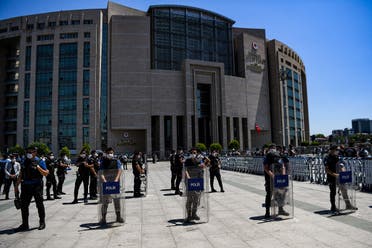 Turkish riot police officers stand guard as lawyers demonstrate in front of Istanbul's courthouse, on June 30, 2020, during a demonstration against a draft law which aims to change the existing structure of bar associations. (AFP)
