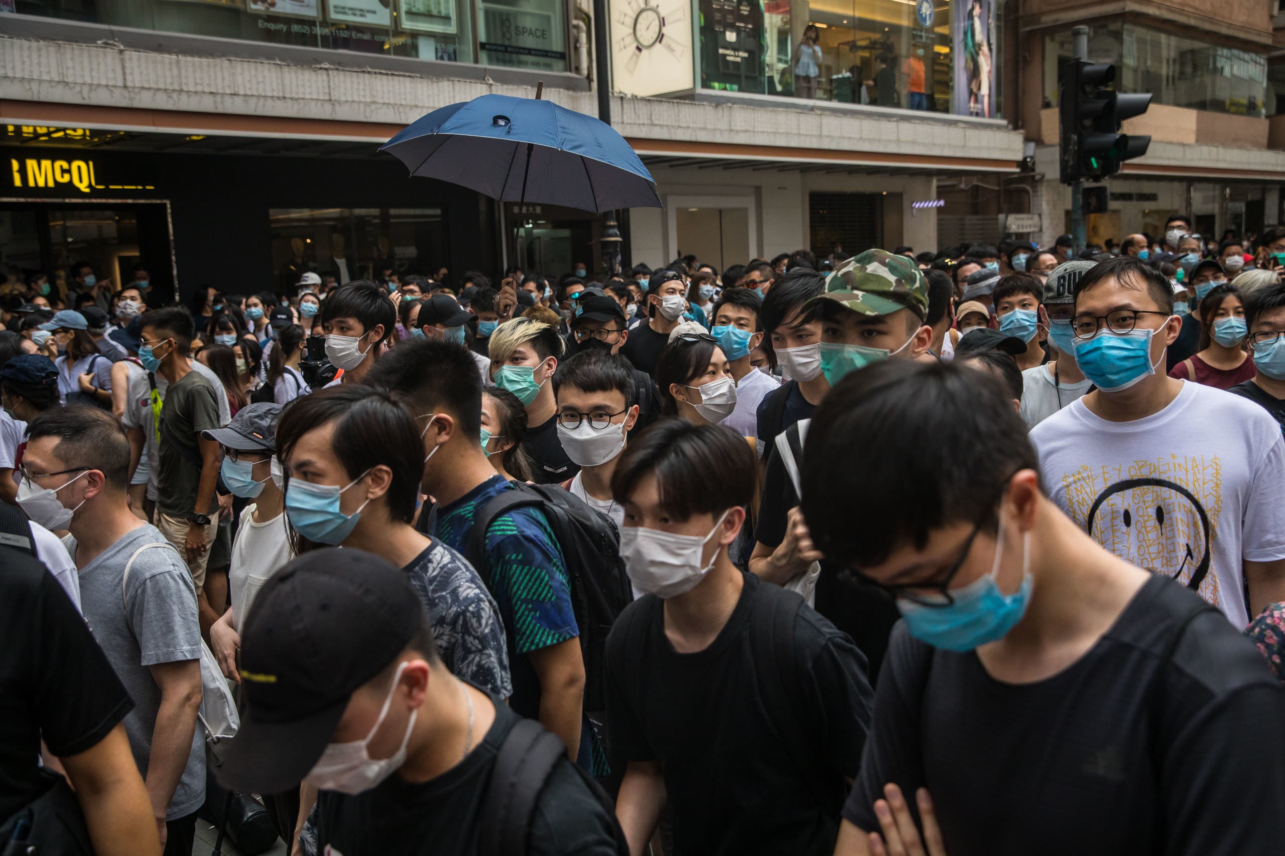 Protests march on a street during a rally against a new national security law in Hong Kong on July 1, 2020, on the 23rd anniversary of the city's handover from Britain to China. (AFP)