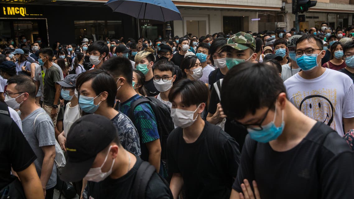 Protests march on a street during a rally against a new national security law in Hong Kong on July 1, 2020, on the 23rd anniversary of the city's handover from Britain to China. (AFP)