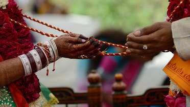 An Indian visually impaired bridal couple participate in Hindu rituals during a mass marriage at the Andh Kanya Praksh Gruh in Ahmedabad on January 19, 2014. (AFP)