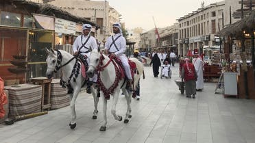 Men in traditional costume ride on horses at souq Waqif, following the outbreak of coronavirus, in Doha, Qatar March 12, 2020. (Reuters)