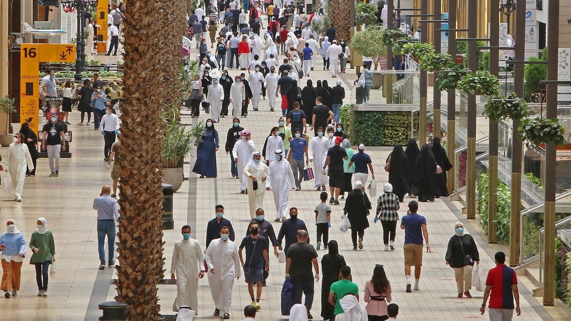 Kuwaitis wearing face masks walk inside the re-opened Avenues Mall, the country's largest shopping centre, on June 30, 2020 in Kuwait City. (AFP)