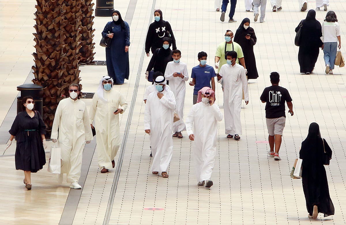 Kuwaitis wearing face masks walk inside the re-opened Avenues Mall, the country's largest shopping centre, on June 30, 2020 in Kuwait City. (AFP)