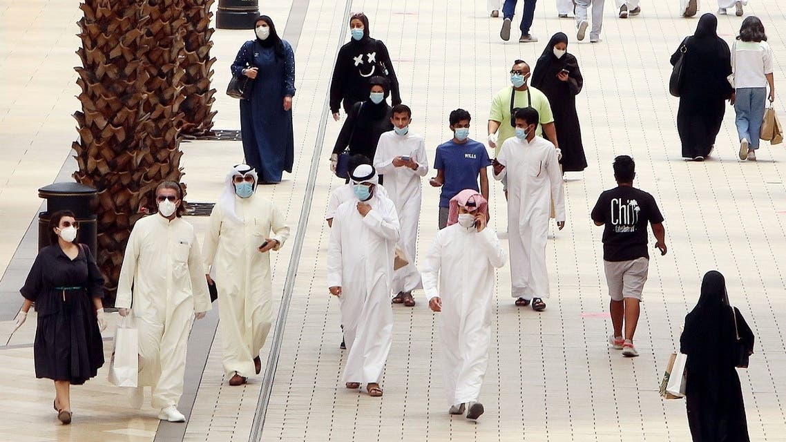 Kuwaitis wearing face masks walk inside the re-opened Avenues Mall, the country's largest shopping centre, on June 30, 2020 in Kuwait City. (AFP)