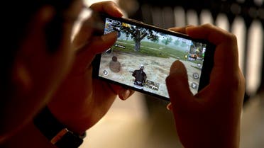 An Indian boy plays an online game PUBG on his mobile phone sitting outside his house in Hyderabad, India, Friday, April 5, 2019. (AP)