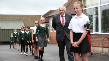 Britain's Prime Minister Boris Johnson joins a socially distanced lesson during a visit to Bovingdon Primary School in Bovingdon, Hemel Hempstead, Hertfordshire. (AFP)